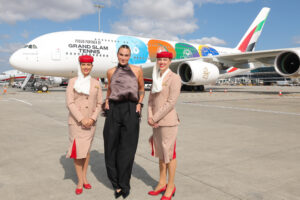 Aryna Sabalenka stands beside an Emirates A380 aircraft featuring a tennis-inspired livery celebrating the airline’s sponsorship of all four Grand Slam tournaments.