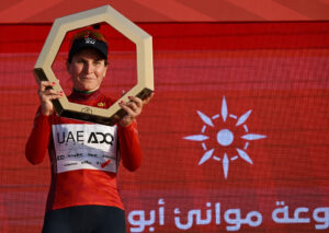 Elisa Longo Borghini celebrating overall victory at the UAE Tour Women in the UAE Team ADQ jersey.
