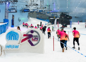 DXB Snow Run participants running inside Ski Dubai indoor snow environment.