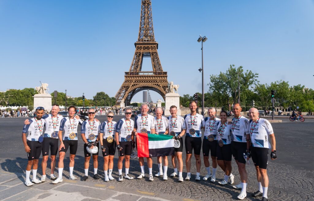 Cycle Against Cancer riders celebrate completing the Barcelona-to-Paris endurance ride.